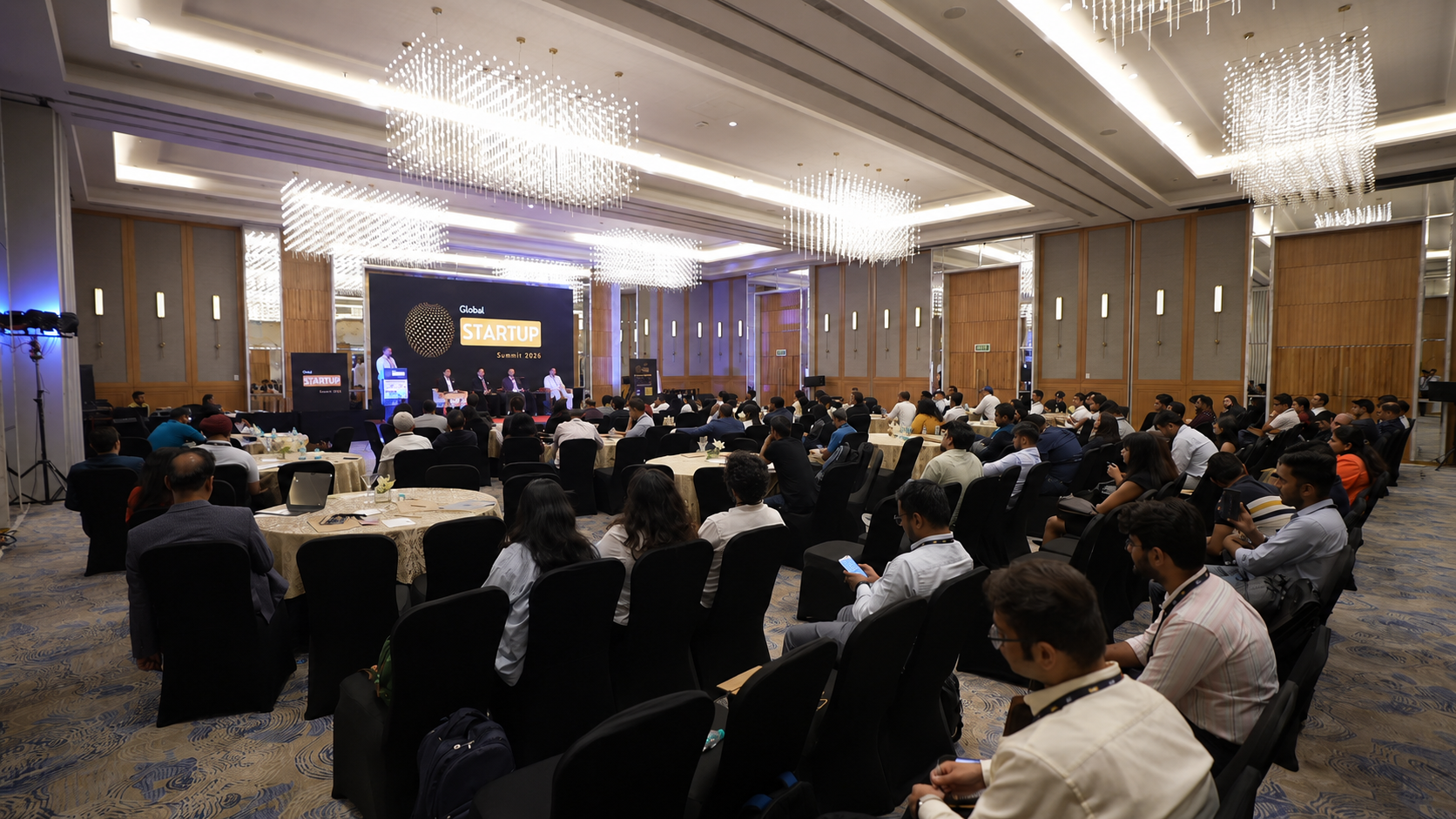 A full Global Startup Summit auditorium with founders and speakers